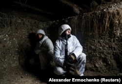 Russia-backed separatists are seen at the front lines near the settlement of Frunze in the Luhansk region on December 24.