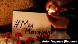 Supporters place flowers and candles at the Solevetsky Stone in St. Petersburg after Russia closed the Memorial International group on the basis of the "foreign agents" law in December 2021.