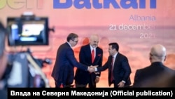 Serbia's Aleksandar Vucic (left to right), Albania's Edi Rama, North Macedonia's Zoran Zaev shake hands at the summit in Tirana on December 21.