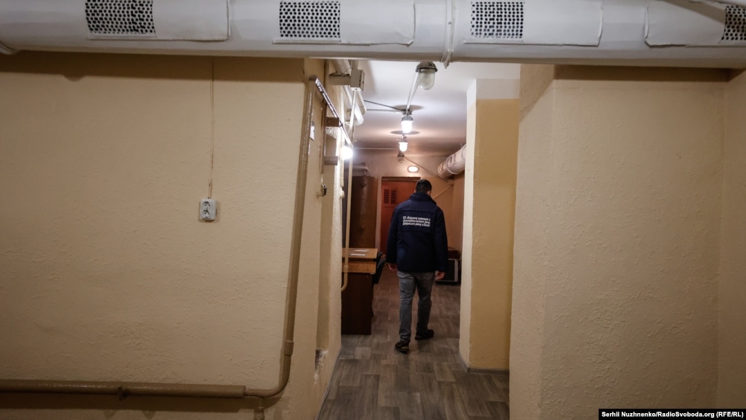 A city official shows journalists through a shelter in the Dniprovskiy region of eastern Kyiv.