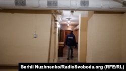 A city official shows journalists through a shelter in the Dniprovskiy region of eastern Kyiv.