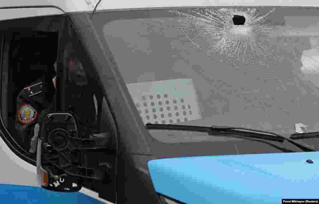 A policeman inside a damaged vehicle in Almaty on January 5.&nbsp;