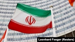 The Iranian flag waves in front of the International Atomic Energy Agency headquarters in Vienna.