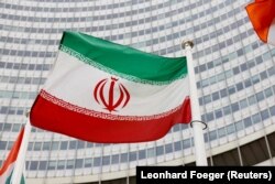 The Iranian flag waves in front of the headquarters of the International Atomic Energy Agency in Vienna.
