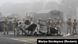 Troops line Almaty's main square on January 6, 2022, as hundreds of people gathered to protest against the government after the authorities' decision to lift price caps on liquefied petroleum gas.