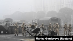 Troops are seen on Almaty's main square, where hundreds of people were protesting against the government after the authorities' decision to lift price caps on liquefied petroleum gas, on January 6, 2022. 