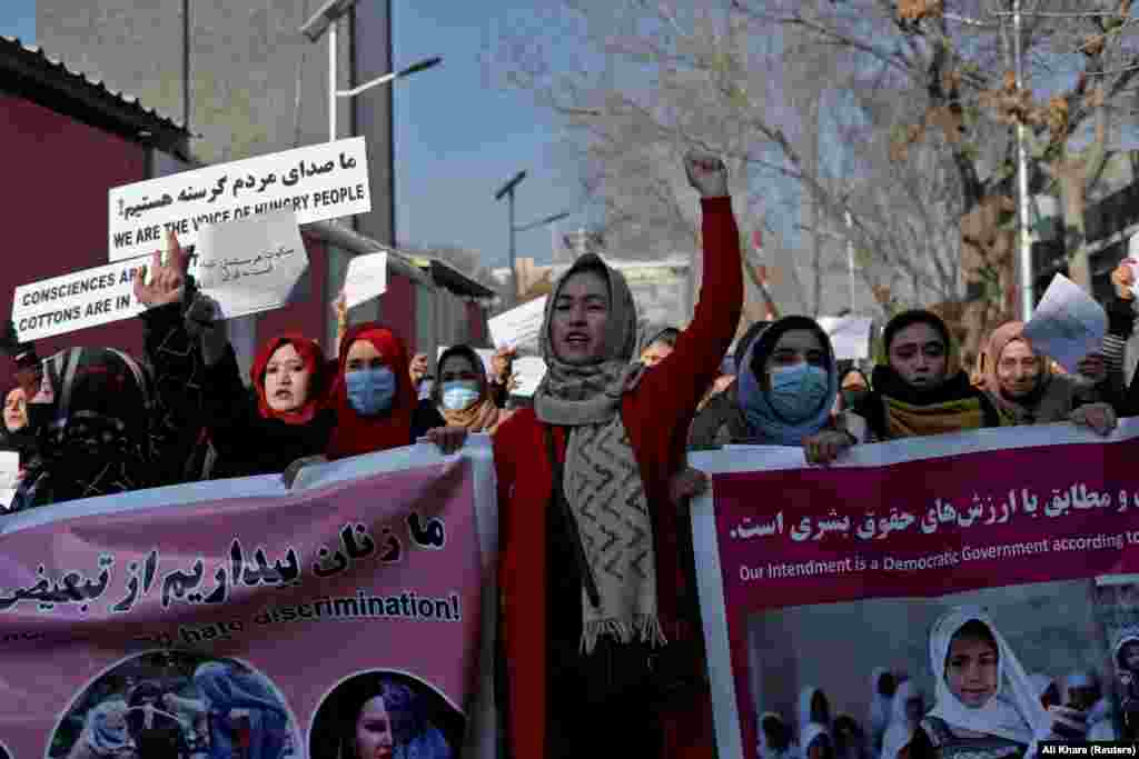 Afghan women shout slogans during a rally in Kabul on December 28 to protest against Taliban restrictions on women.
