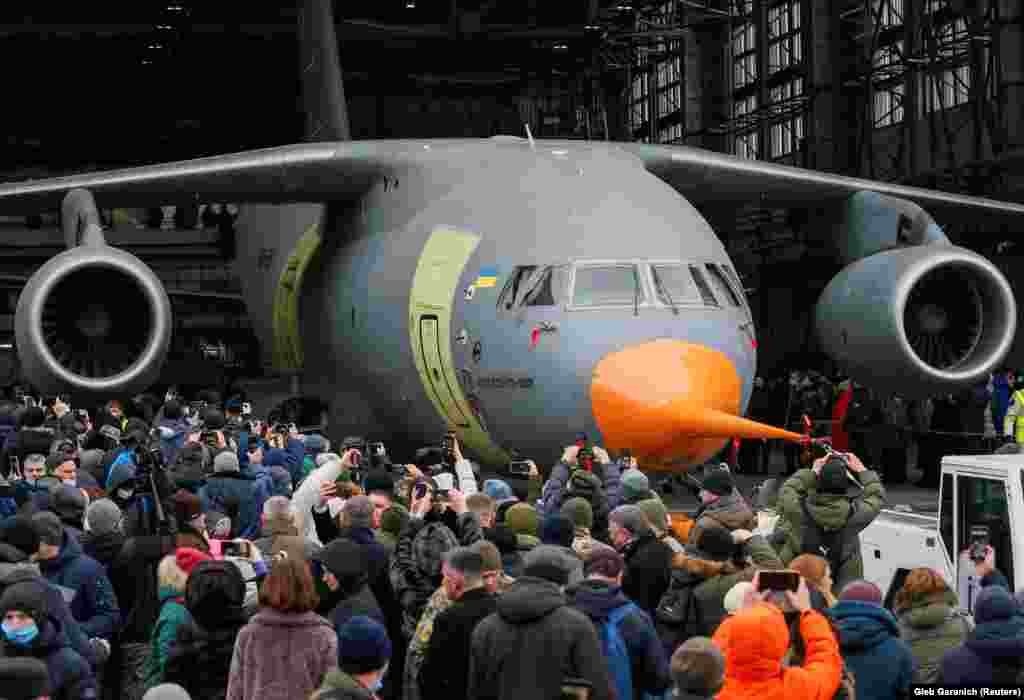 People surround a new military transport aircraft, the Аn-178-100R, designed for the Ukrainian armed forces during its rollout at the Antonov aircraft plant in Kyiv on December 28.