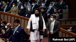 The acting foreign minister in Afghanistan's Taliban-run cabinet, Amir Khan Muttaqi (center), arrives for the extraordinary session of Organization of Islamic Cooperation (OIC) Council of Foreign Ministers in Islamabad in December 2021.
