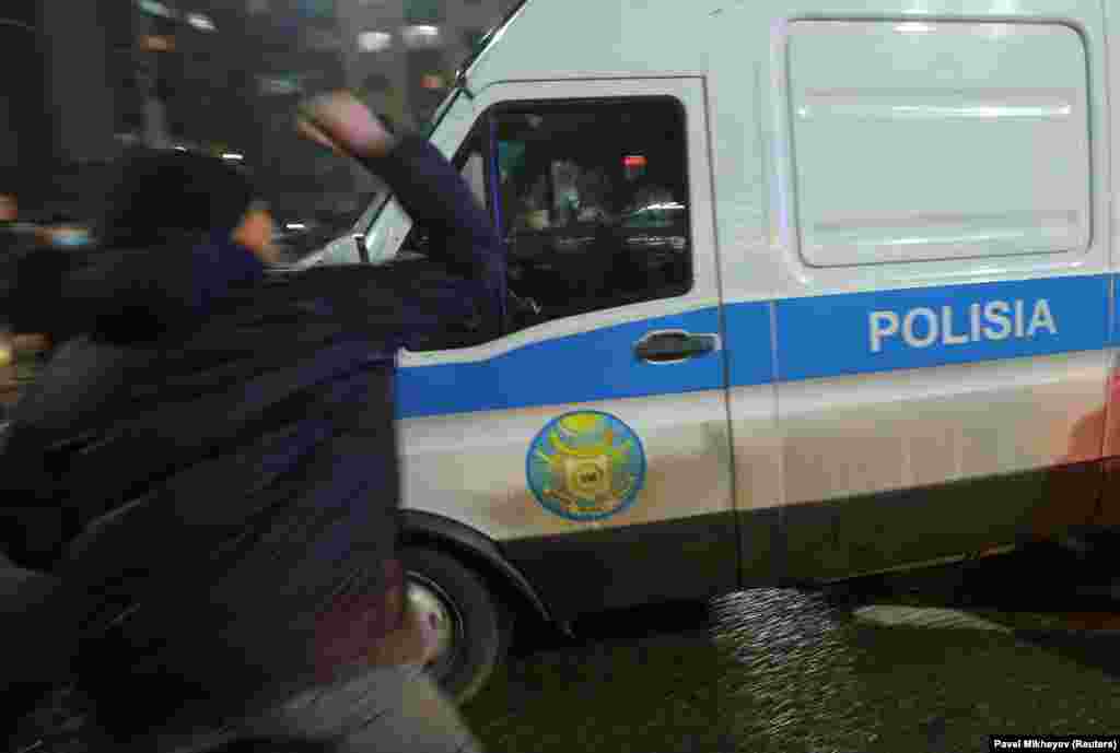 Protesters attack a police van in Almaty as protests turned violent overnight on January 4-5. Police vehicles were set ablaze, and multiple arrests made.&nbsp;