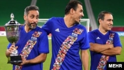 Mehdi Mahdavikia (right) attends FIFA's Arab Legends and World Legends friendly match in Doha, Qatar, on December 17.