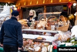 A man stocks up on some seasonal provisions at a Christmas market in Bucharest.