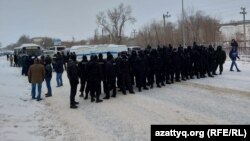 A police quick-reaction unit cordons off the road at a rally in Oral on January 4.