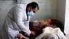 A doctor treats a COVID-19 patient at a hospital in Khost, southeastern Afghanistan.