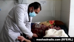 A doctor treats a COVID-19 patient at a hospital in Khost, southeastern Afghanistan.