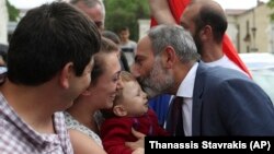 NAGORNO-KARABAKH -- Armenia's Prime Minister Nikol Pashinian kisses a baby after a news conference in Stepanakert, May 9, 2018. Nagorno-Karabakh