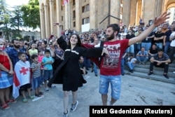 Anti-LGBT protesters dance in front of parliament on July 5 after a planned gay-pride march was called off amid threats of violence.