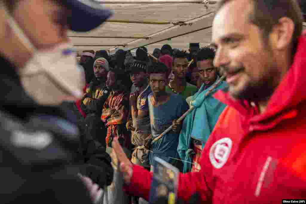 Migrants gather on the deck of the Spanish NGO Proactiva Open Arms vessel after being rescued in the central Mediterranean Sea, before disembarking at the port of Crinavis in Algeciras, Spain. Other European countries such as Italy, Malta, and Greece had closed their ports to the ship. Only Spain admitted entry. (AP/Olmo Calvo)