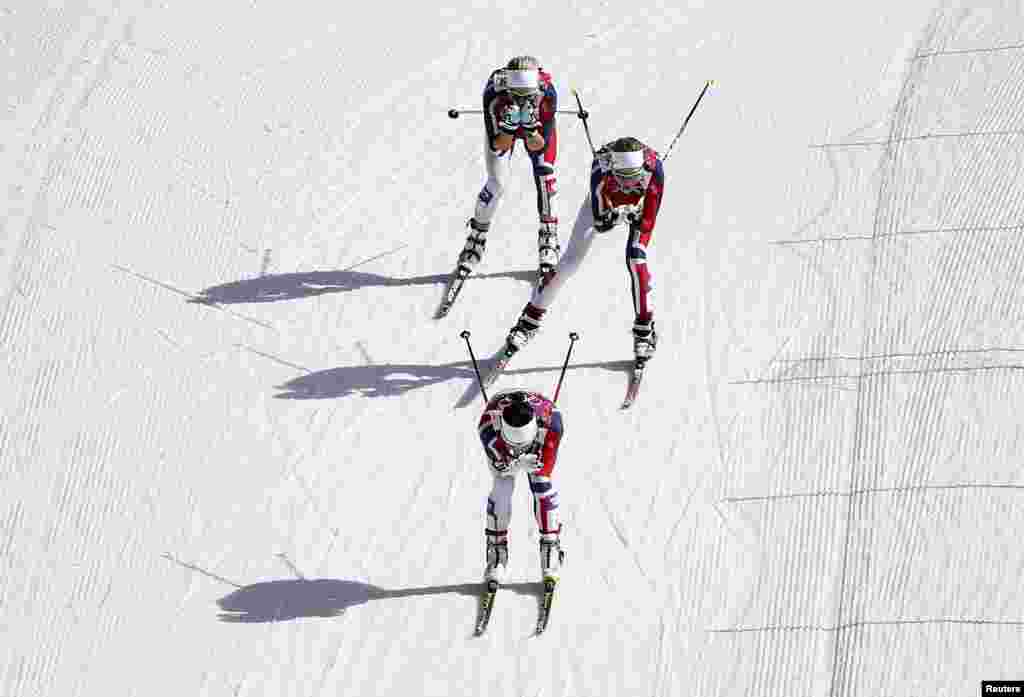 Norway&#39;s Marit Bjoergen (bottom), Kristin Stoermer Steira, and Therese Johaug (top) compete during the women&#39;s cross-country 30-kilometer mass start event. All three won medals. (Reuters/Carlos Barria)