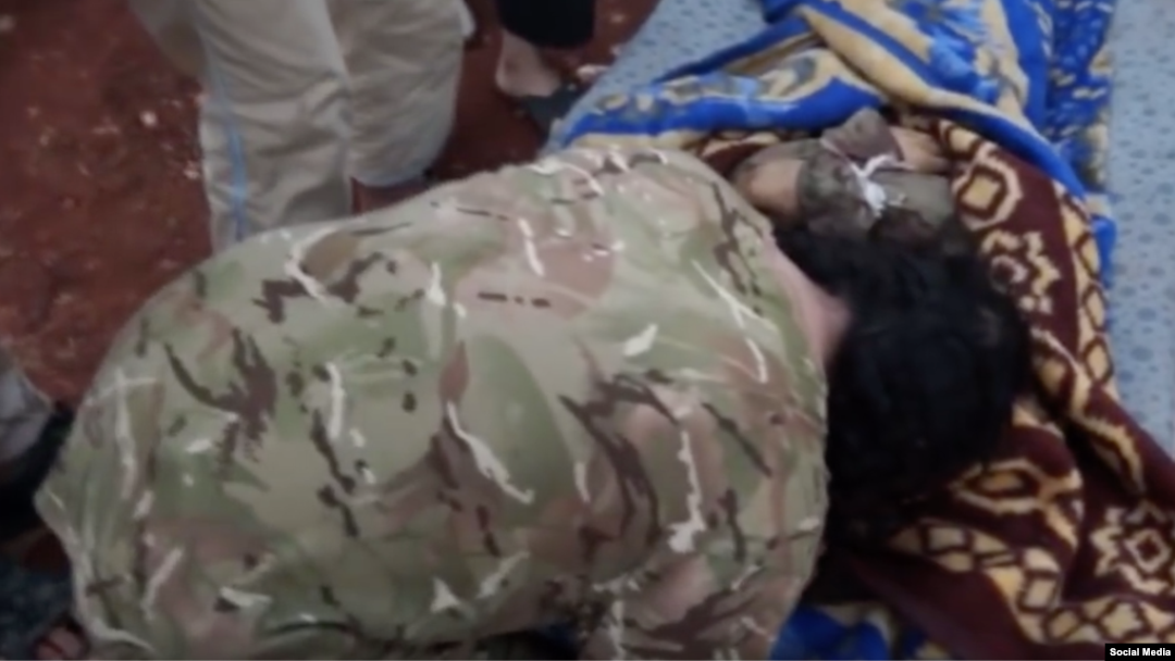 Uzbek militant commander Salahuddin buries his 16-year-old son.