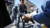 Полицейские задерживают участника акции в поддержку Украины. Москва, 1 мая 2014 года.
