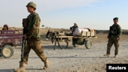 FILE: Afghan National Army (ANA) troops keep watch at a check point in Aqcha district of Jawzjan province in November 2017.