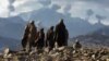 Afghanistan -- Anti-Taliban Afghan fighters watch several explosions from U.S. bombings