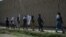 FILE: Afghan Taliban militants walk in the outskirts of the eastern city of Jalalabad.