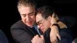 Siamak Namazi (right) is embraced by a relative upon returning to the United States last year after being imprisoned in Iran for eight years. 