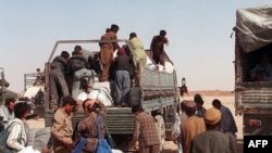 Afghan refugees reload luggage in Islam Qala, on the border with Iran, where up to 1.5 million Afghans still live, many illegally.