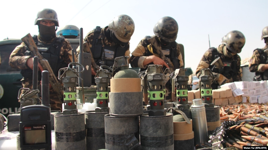 Afghan National Directorate of Security officers display weapons and ammunition seized during operations against Taliban militants, in Helmand on February 18. The UN says that violence in Afghanistan has increased in recent months.