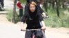 Iran -- Women on bicycle in a park in Iran, Apr2011
