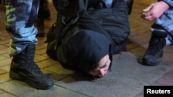 Russian police officers detain a man during an opposition rally in Moscow. (file photo)