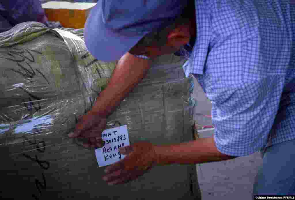 Abdullah adds a handwritten shipping label to one of his packages.