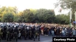 Iranian riot police confront protesters in Tehran on September 19.