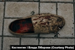A woman's shoe is covered in blood after Russia shelled a public transport stop in Mykolayiv. Five people were killed.