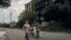 Residents walk past a war-damaged building in the center of the recently liberated town of Izyum in Ukraine's Kharkiv region on September 13. 