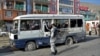 A security personnel visits the site of a blast in Kabul on March 18 that hit a bus carrying government employees.