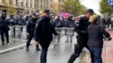 The police remove the girl in front of the cordon in Belgrade