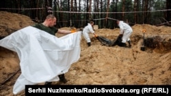 Investigators unearth Ukrainian soldiers whose bodies were found with their hands tied near Izyum following Russia's occupation of that city. 