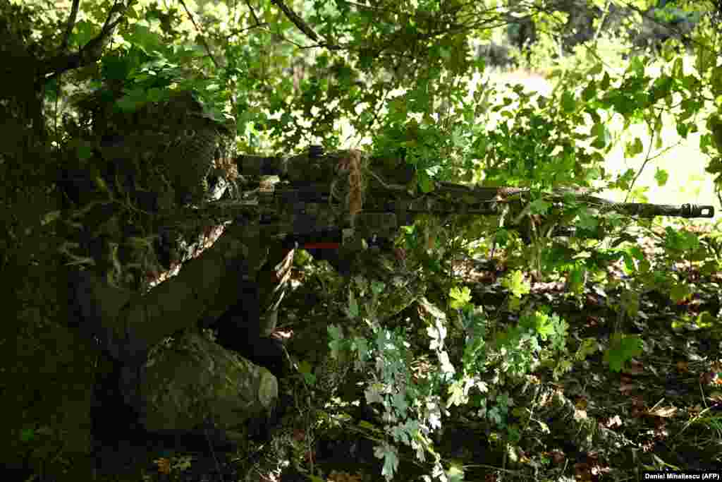 A Dutch sniper takes part in a training exercise at the Cincu training facility on September 20. Minguet said regular drills at the site were &quot;part of a message we are sending to the Russian Army.&quot; &nbsp;