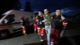 Paramedics help a Ukrainian prisoner of war whom Russia swapped at an exchange in the Chernihiv region.