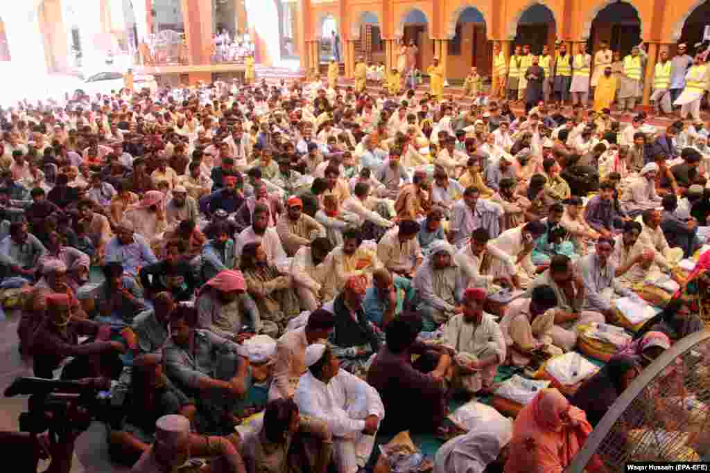 A crowd of men affected by the floods await handouts organized by an Islamist political party in the southern city of Larkana.&nbsp; Pakistani officials say it will take at least two months for the floodwaters to fully recede.&nbsp;