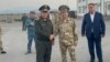 Kyrgyz and Tajik security chiefs Kamchybek Tashiev (left) and Saimumin Yatimov shake hands at the Guliston-Avtodorozhny border crossing on September 19.