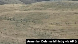 A screenshot from a YouTube footage released by Armenian Defense Ministry on September 13, 2022 shows Azerbaijanian servicemen crossing the Armenian-Azerbaijani border and approaching the Armenian positions. 