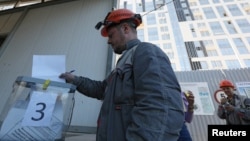A construction worker casts his ballot during a referendum on joining Russia in Sevastopol, Crimea, on September 26.