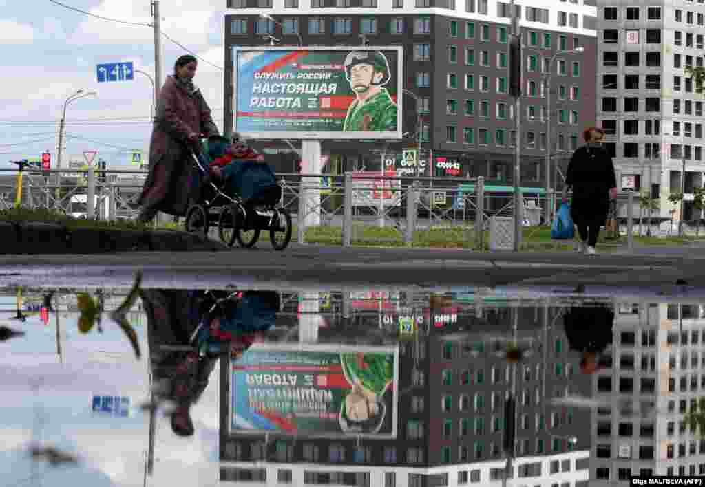 A billboard advertises contracts with the Russian Army in St. Petersburg with the image of a serviceman and a slogan reading: &quot;Serving Russia is a real job.&quot;&nbsp;