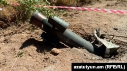 Armenia - The tail of an unexploded rocket sticks out by the main road leading out of Jermuk, September 16, 2022.