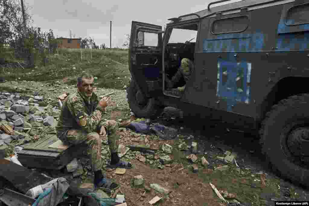 Ukrainian soldiers take a break in liberated territory in the Kharkiv region.