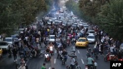 A photo obtained by AFP shows Iranian demonstrators taking to the streets of the capital, Tehran, during a protest on September 21 for Mahsa Amini, days after she died in police custody.